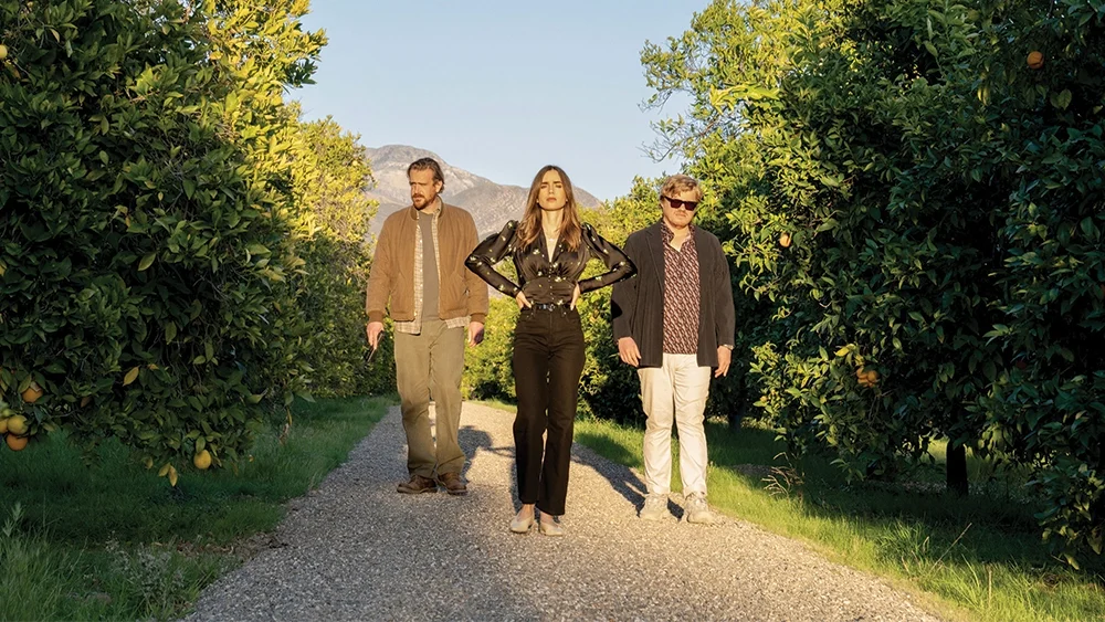 The main cast of Windfall in an orange grove