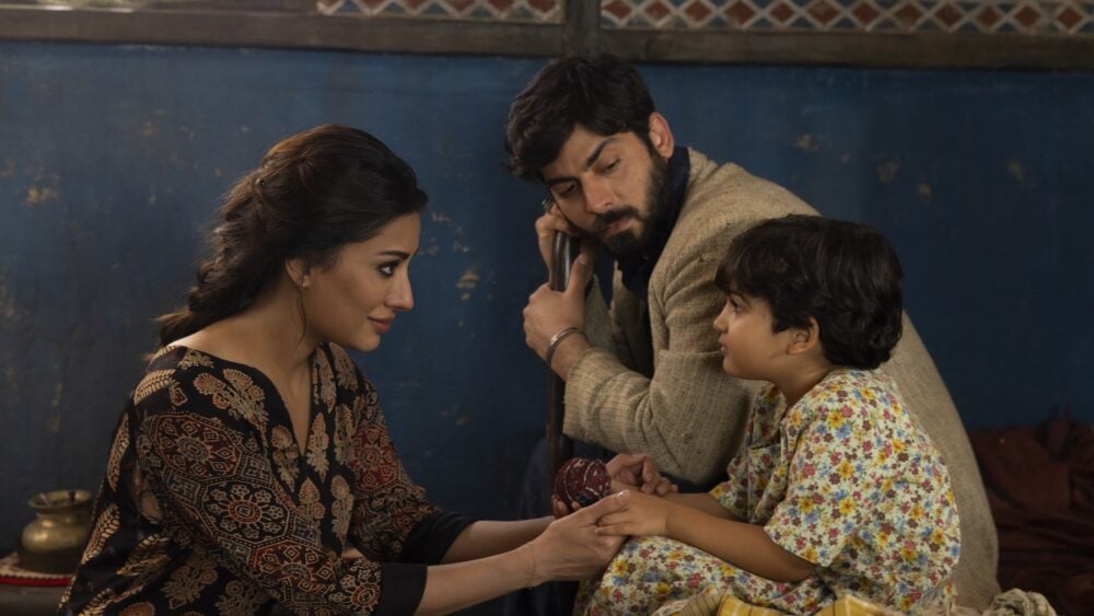 Mehwish Hayat as Aisha, Fawad Kahn as Hasan, and Zion Usman as Young Sana in Marvel Studios' MS. MARVEL